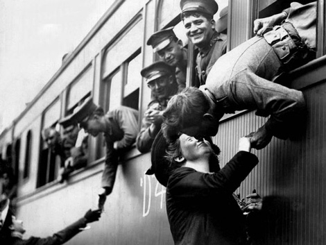 Soldiers leaving on train as loved ones say goodbye.